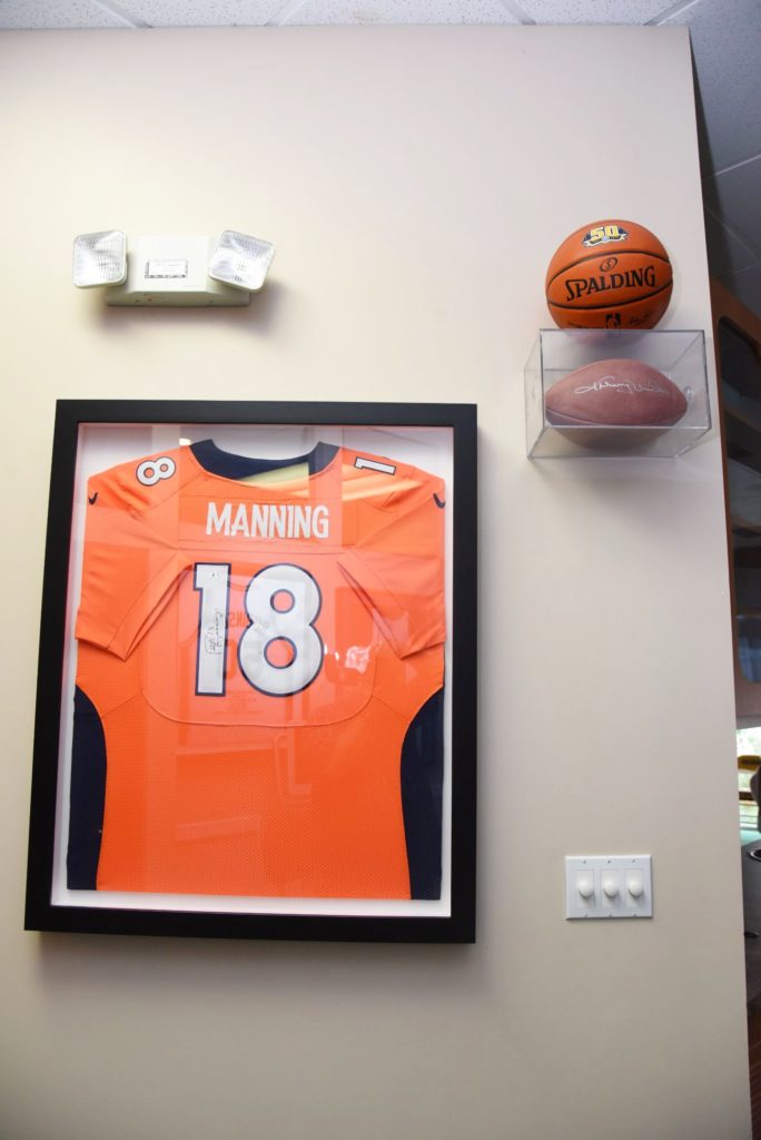 Manning jersey framed on the wall