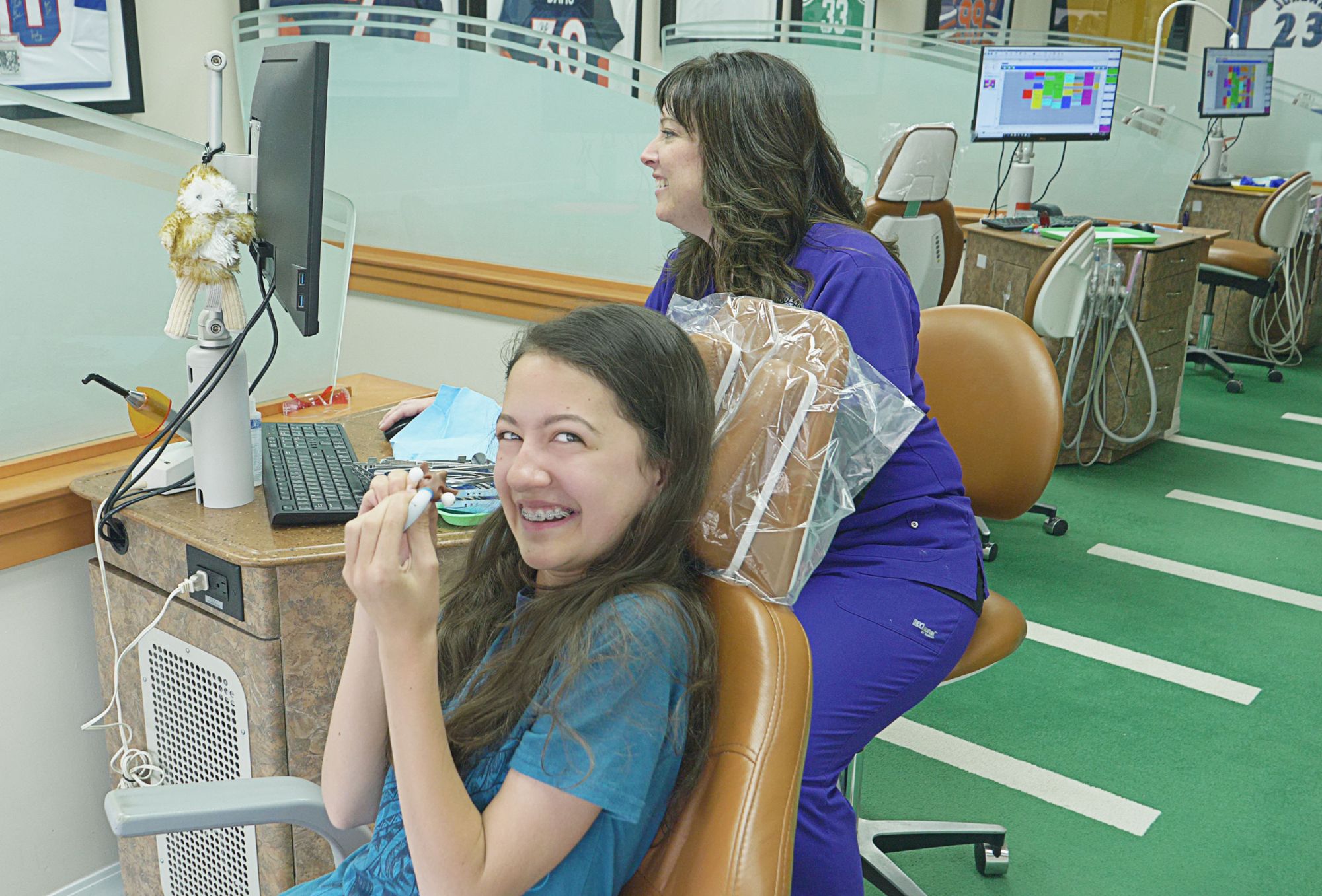 patient with braces smiling in examination chair